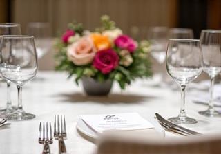 Sophisticated corporate event table setting with elegant floral arrangements